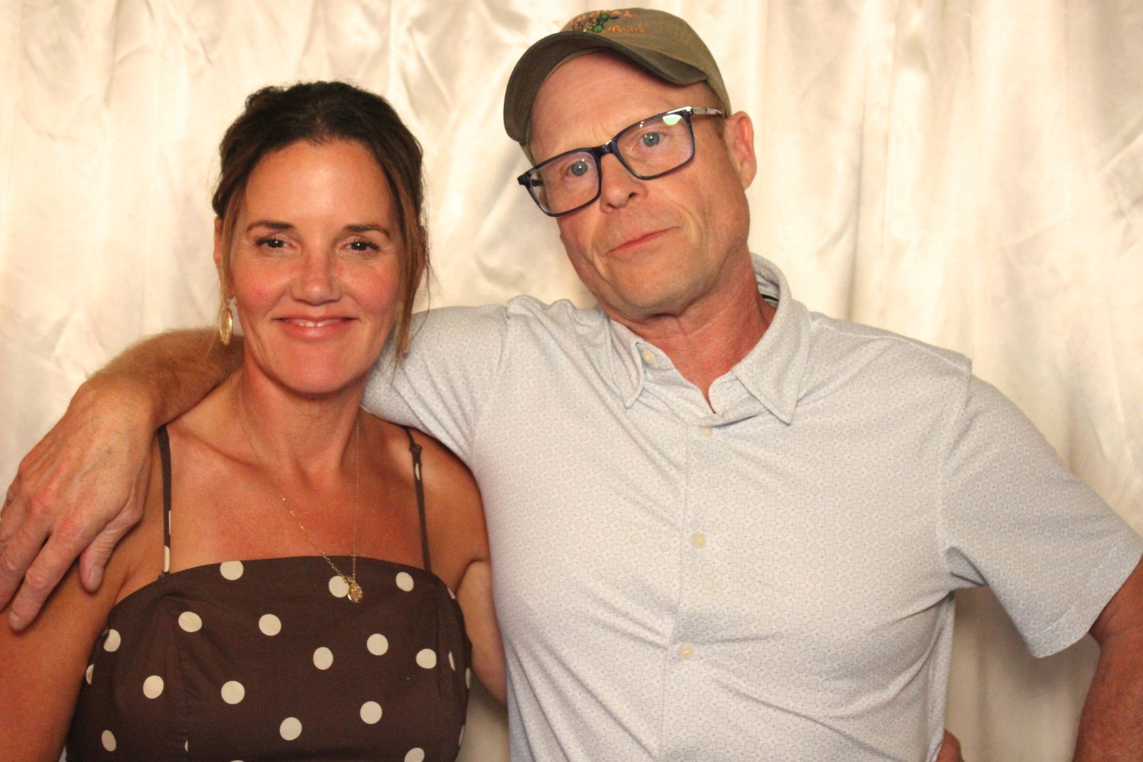 Smiling couple posing together in the freestanding photo booth